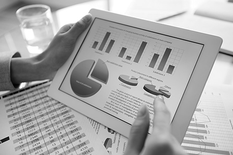 picture of tablet with charts illustrating data and someone holding it